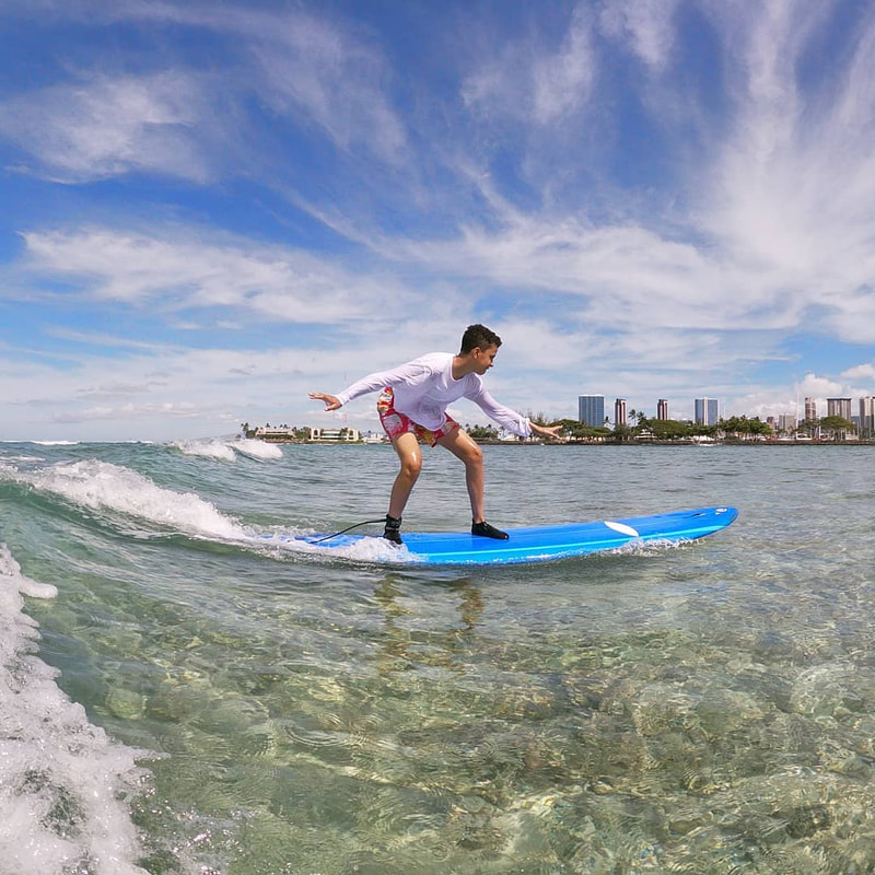 A young boy riding a wave. Provided by Polu Lani Surf.