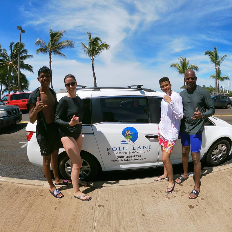 Family of 4 throwing shakas in front of the Polu Lani Surf Van after their private surfing lesson. Provided by Polu Lani Surf