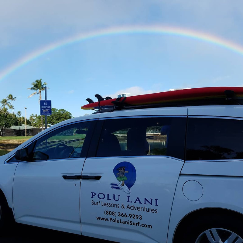 Photo of the Polu Lani Surf van with a beautiful rainbow above it against a clear blue day. Provided by Polu Lani Surf.
